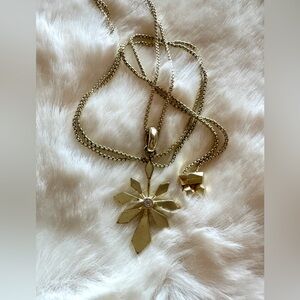 Kendra Scott gold sunburst pendant necklace.
